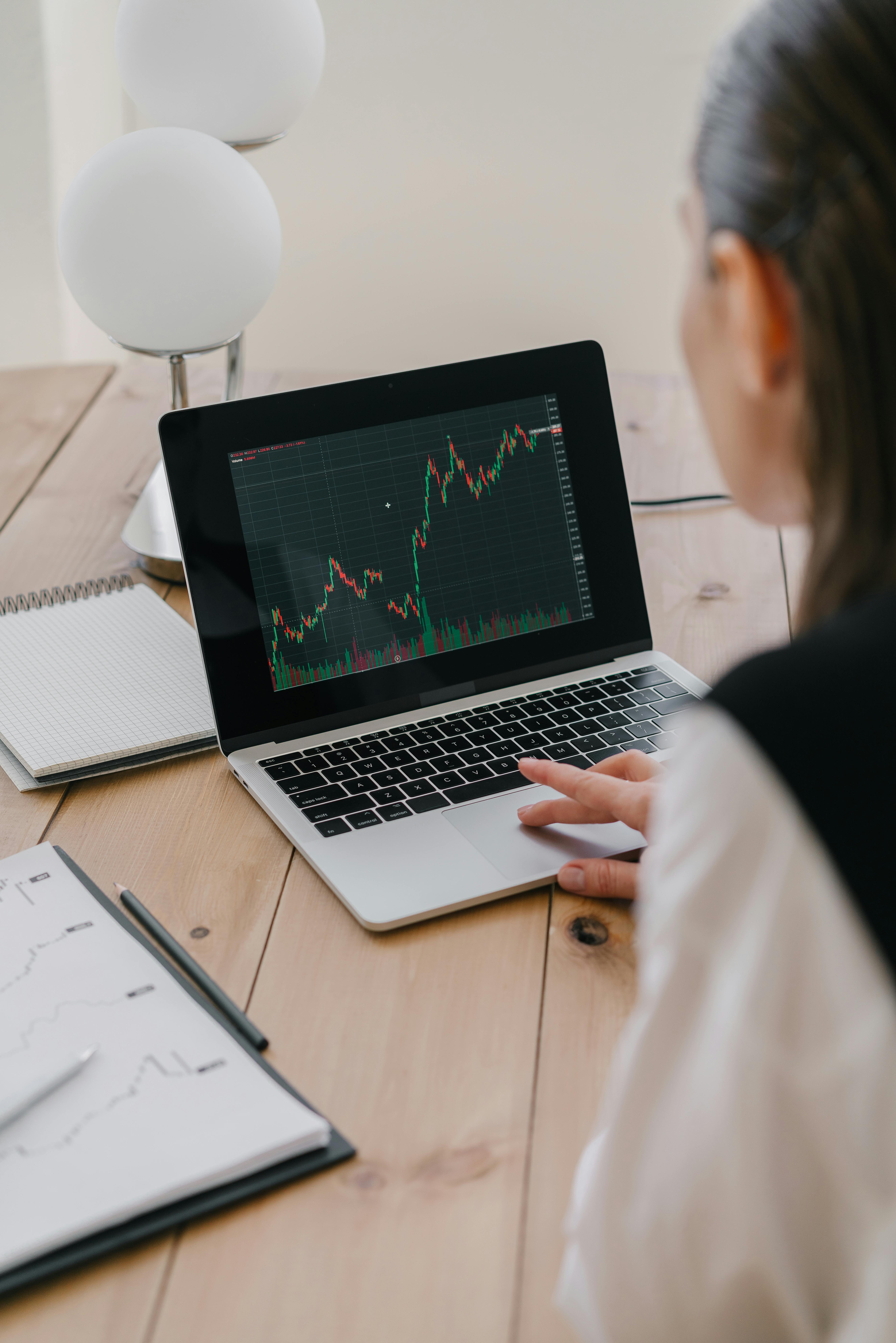 Female investor studying market data on her laptop